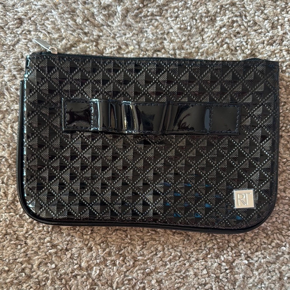 Black makeup brush bag with brush holder on outside as well